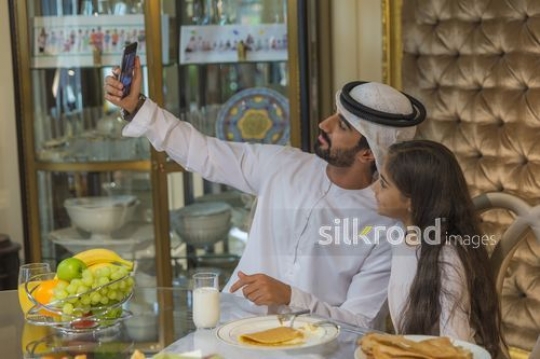Arab man taking a selfie with the young girl|