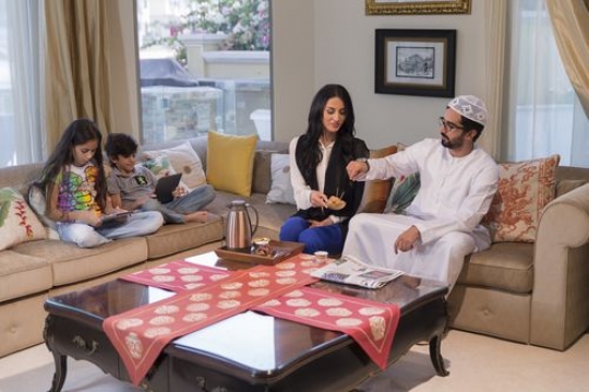 Man taking arabic sweets from his wife while|-