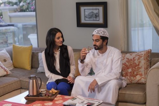 Middle eastern man and woman sitting together|-