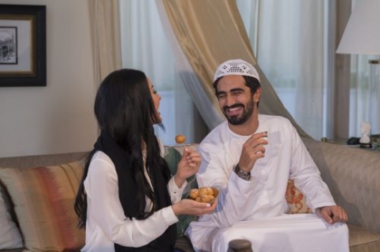 Middle eastern man and woman sitting together |-