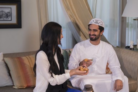 Arab man and woman sitting together|-