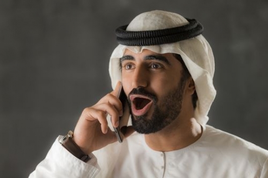 Arab man excited on the phone|-