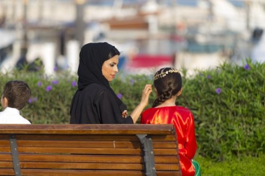 Mother and daughter sitting on the bench|-
