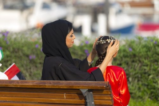 Mother helping her daughter wear the traditional gold head jewellery |-