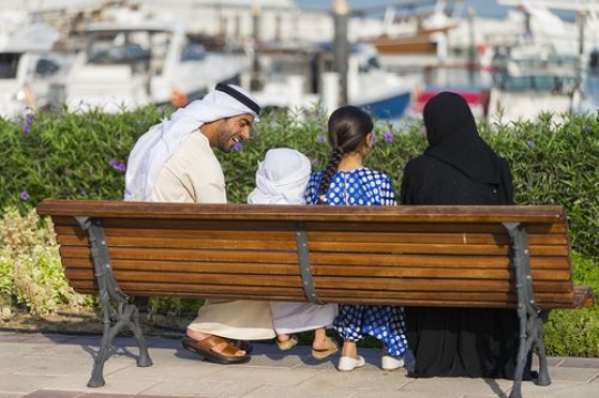 Family sitting on the bench spending time together|-