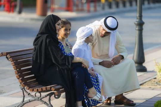 Arab family dressed in traditional attire spending time together|-