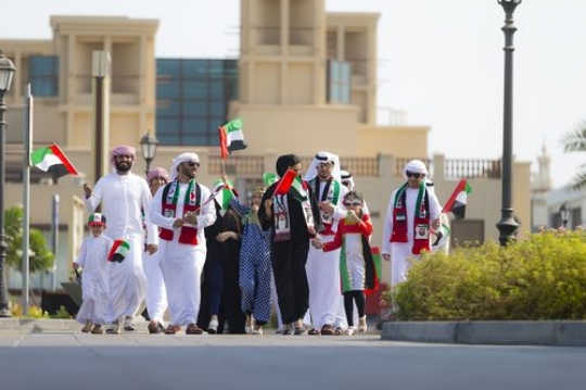 Family and friends representing their country during a national day parade|
