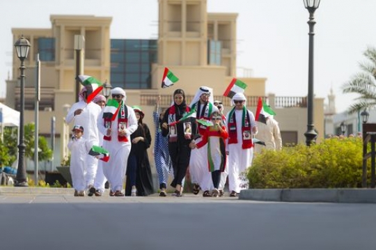 Arab family and friends at a parade celebrating national day|