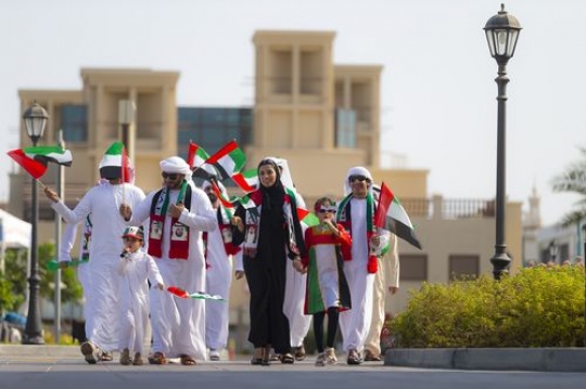 Family and friends at a parade, celebrating National day|