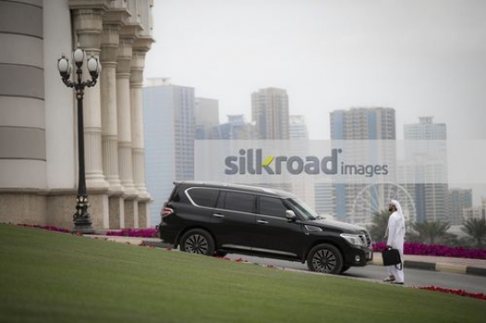Businessman dressed in the traditional UAE attire walking|