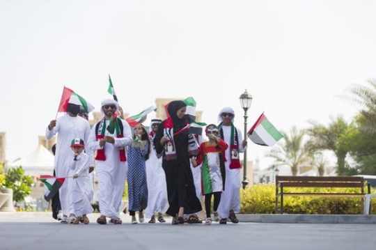 Family and friends representing their country at a National Day Parade|