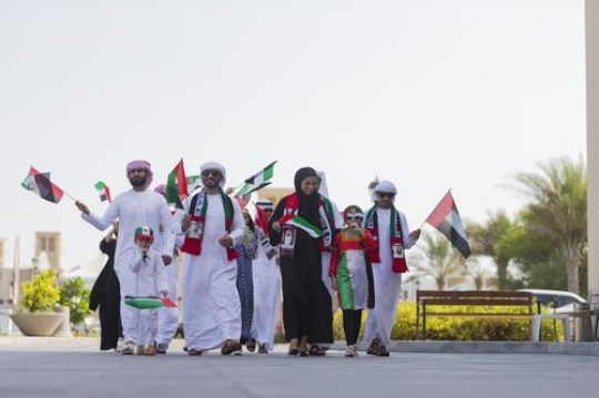 Arab family and friends representing their country at a National Day parade|