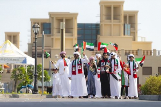 Middle eastern family celebrating National Day|
