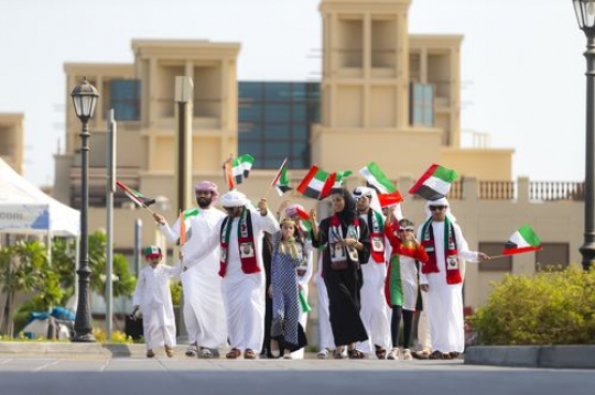 Middle eastern family and friends at a Parade, celebrating National Day|