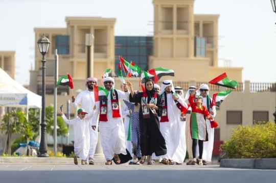 Arab family proudly representing their country during a National Day Parade|