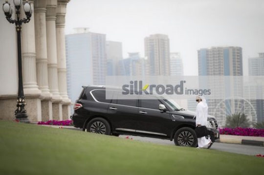 Arab Businessman dressed in the traditional attire walking|