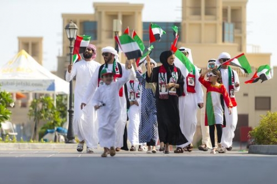 Friends and family representing their country during UAE National Day|