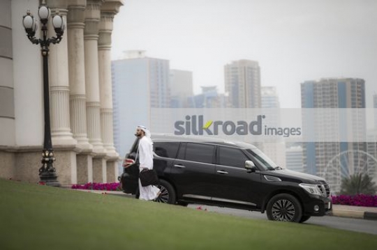 Businessman dressed in the traditional attire walking|