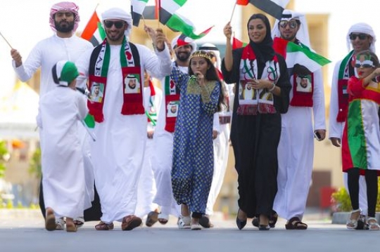 Arab family representing their country during a National Day Parade|