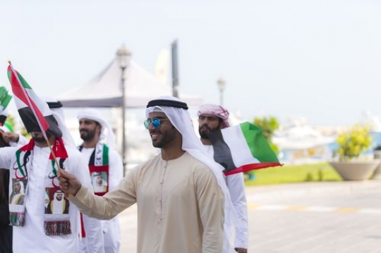 Arab man at a UAE National Day parade|