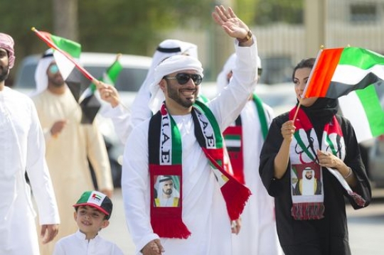 Arab family dressed in the traditional attire celebrating UAE National Day|
