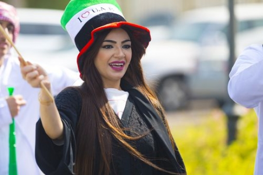 Arab woman dressed in the traditional attire celebrating UAE National Day|