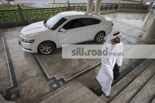 Middle Eastern Businessman walking and talking on the phone|