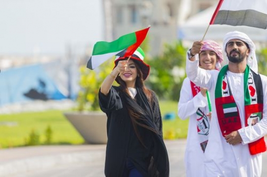 Arab men and woman celebrating National Day|