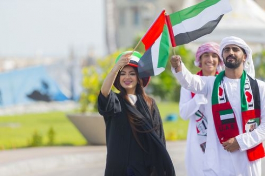Arab man and woman celebrating National Day|