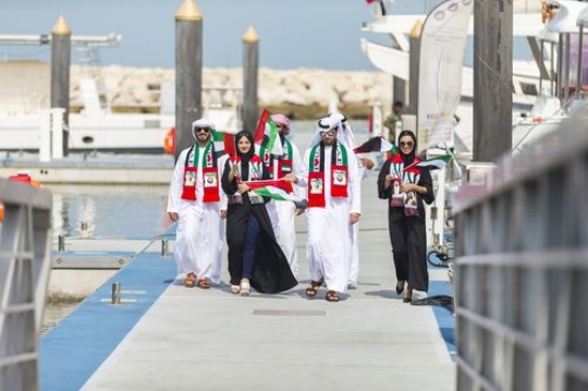Family and friends at a parade by the dock celebrating National Day|