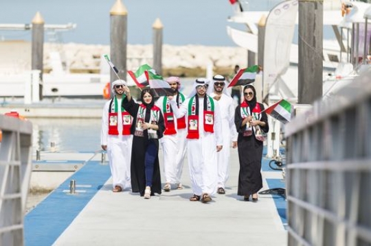 Family and friends dressed in the UAE traditional attire celebrating National Day|