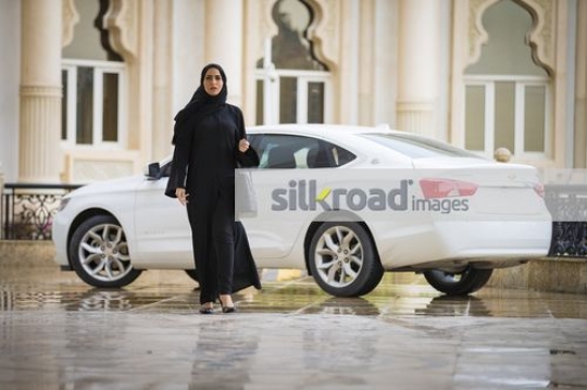 Middle Eastern Businesswoman dressed in the traditional attire walking|