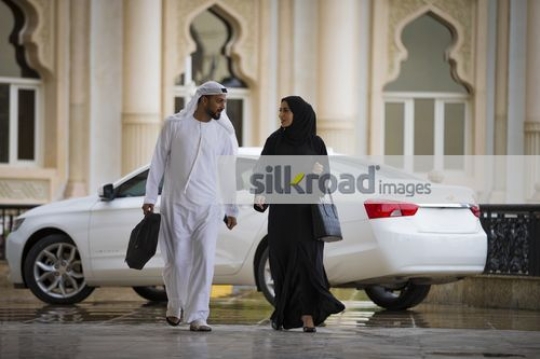 Middle Eastern Business man and woman walking|
