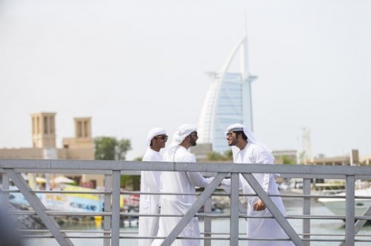 Arab men greeting each other in the UAE traditional way|