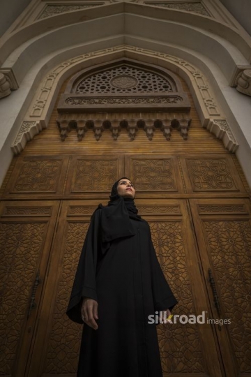 Low Angle shot of a Middle Eastern Businesswoman standing infront of gate|-