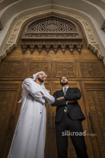 Arab Businessmen standing with their arms crossed|-