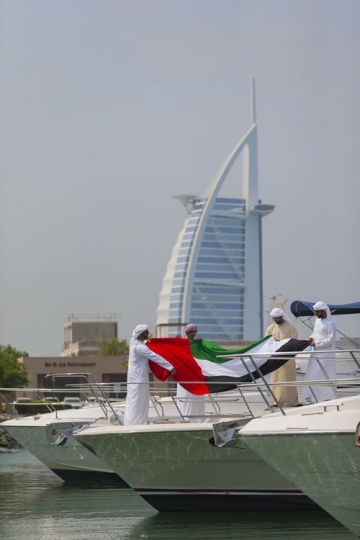 Arabian men celebrating National Day on a Yacht|