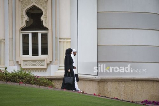 Middle Eastern Businessman and Businesswoman walking together|-