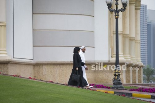 Businesswoman and Businessman walking outside together|-