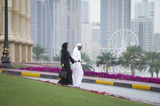 Middle Eastern man and woman walking alongside each other|-