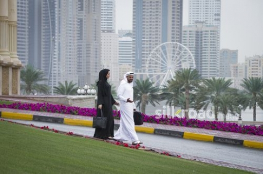 Businessman and business woman walking alongside each other|-