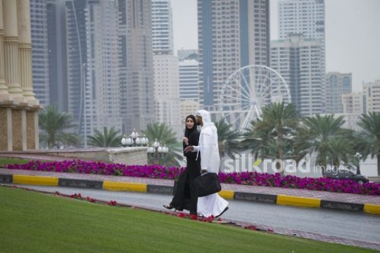 Arab businessman and business woman walking together|-