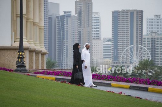 Arab Businessman and Businesswoman walking together|-