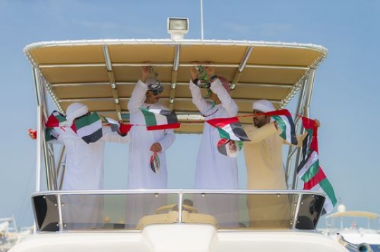 A group of men preparing for the UAE National Day|