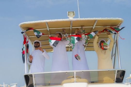 Arabian men decorating the Yacht for celebrations of the UAE National Day|
