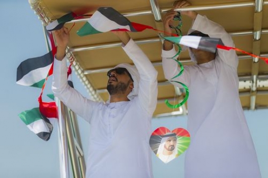 Arab men representing their country by decorating the Yacht for UAE National Day|