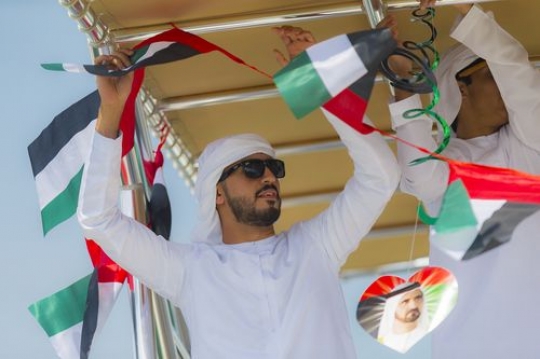 Arab man celebrating the UAE National Day while decorating the Yacht|