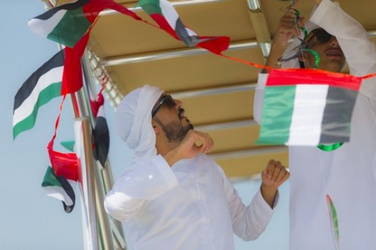 Arab man preparing for the UAE National Day|