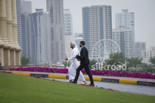 Arab businessmen walking together|-