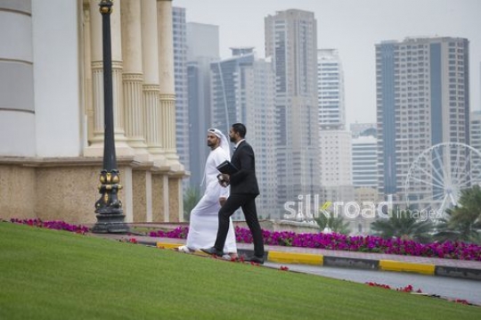 Middle Eastern business men walking together|-
